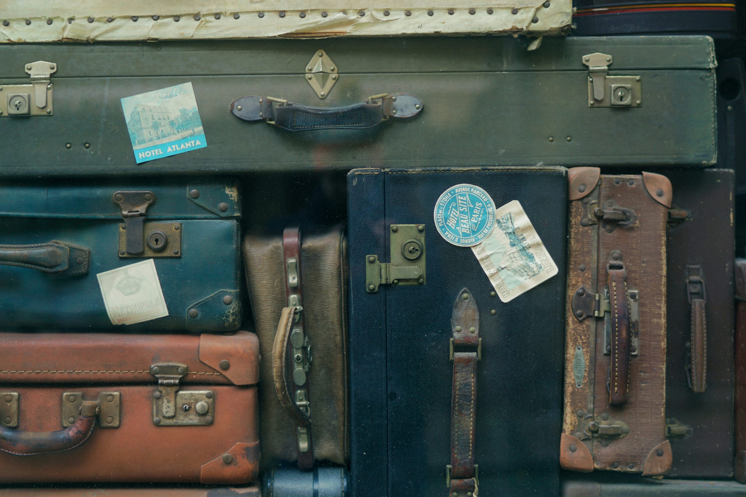 suitcases with tags stopped on top of each other